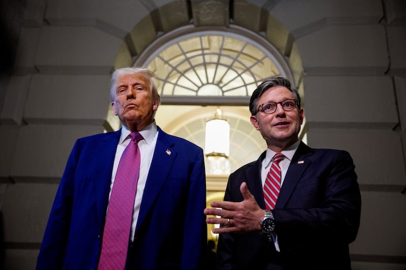 Speaker Mike Johnson speaking to reporters with President Donald Trump as they depart a House Republican meeting on May 20, 2025.