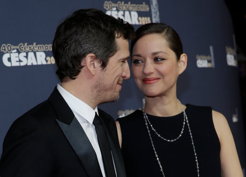 Actress Marion Cotillard (R) and actor Guillaume Canet pose as they arrive at the 40th Cesar Awards ceremony in Paris February 20, 2015.                REUTERS/Christian Hartmann (FRANCE  - Tags: ENTERTAINMENT TPX IMAGES OF THE DAY)